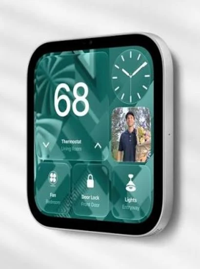 Apple HomeView mounted on a wall, its screen showing a thermostat, a clock, a photo and controls for a fan, a door lock and lights