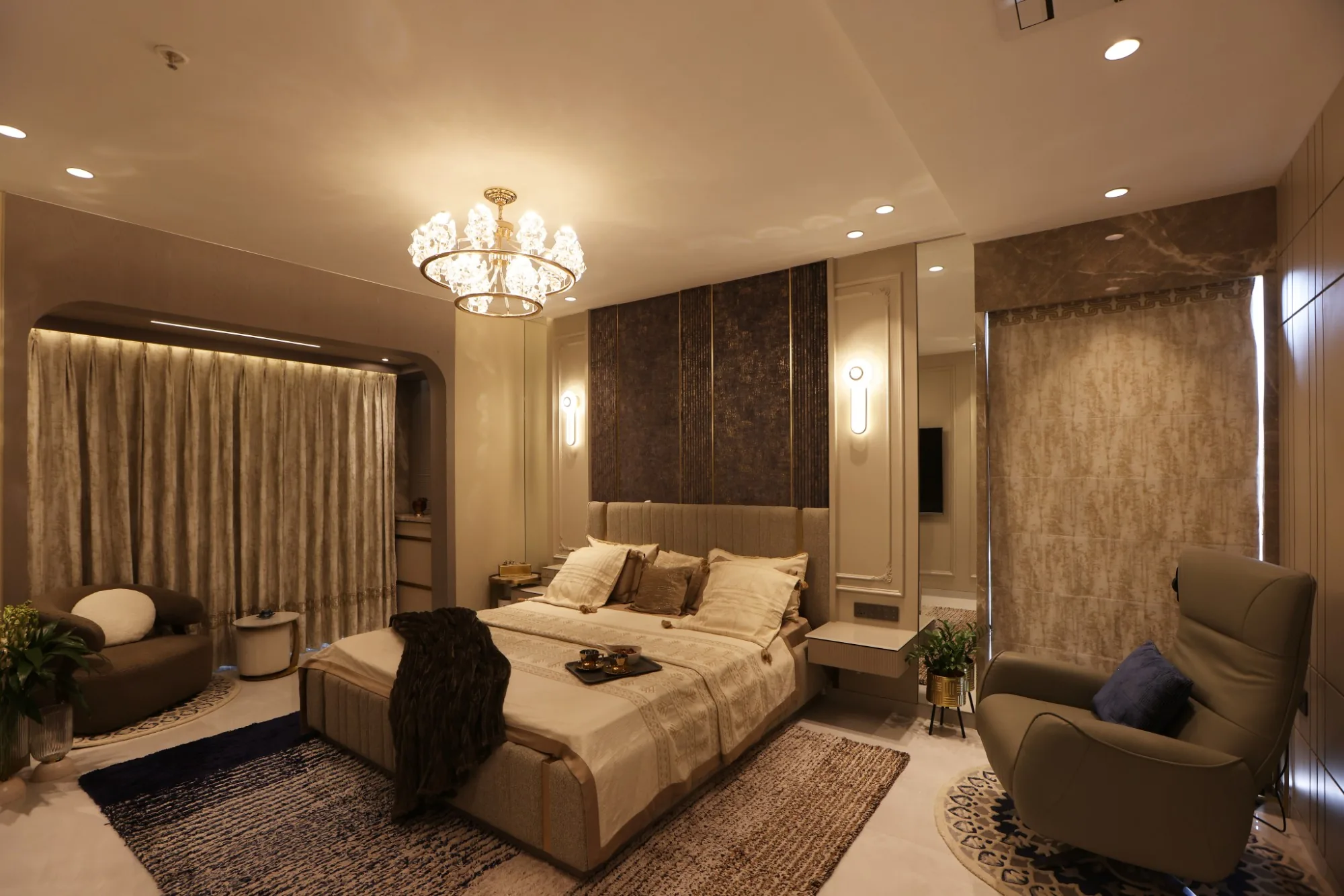 Master bedroom on a warm evening scene, with wall lights either side of the bed and full-height curtains